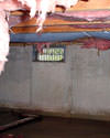 Minnesota and Wisconsin crawl space with vents, showing mold, rot, and fiberglass insulation dripping off the ceiling.