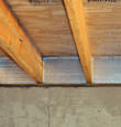 SilverGlo™ insulation installed in a floor joist in Crosby