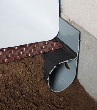 Closeup of a crawl space drainage system installed in Rush City