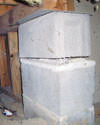 Concrete crawl space support posts in Eveleth that are showing signs of failure as they sink into the earth.