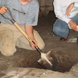 Digging a hole for the engineered fill used in a crawl space support system installation in Cloquet