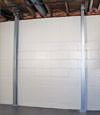 A steel i-beam system installed on a Cass Lake foundation wall