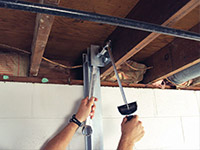 Straightening a foundation wall with the PowerBrace™ i-beam system in a Hayward home.