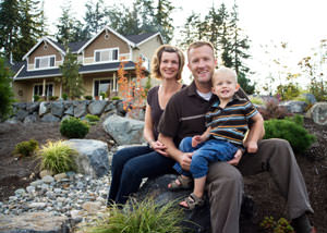 A happy family outside a home with a repaired foundation in Pequot Lakes