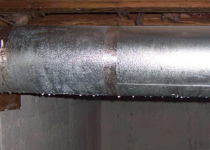 condensation collecting on an HVAC vent in a humid Crosby basement