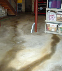 Flooding entering a basement through a floor crack in Ely