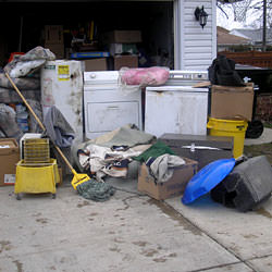 Soaked, wet personal items sitting in a driveway, including a washer and dryer in Cloquet.