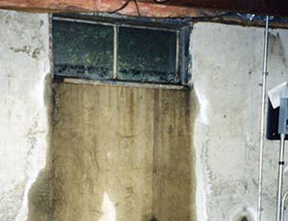 Water pouring out from a basement window in Grand Rapids