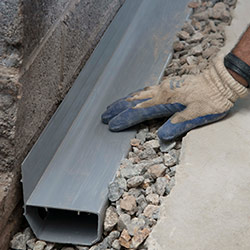 installing a drain tile system in a Baxter home